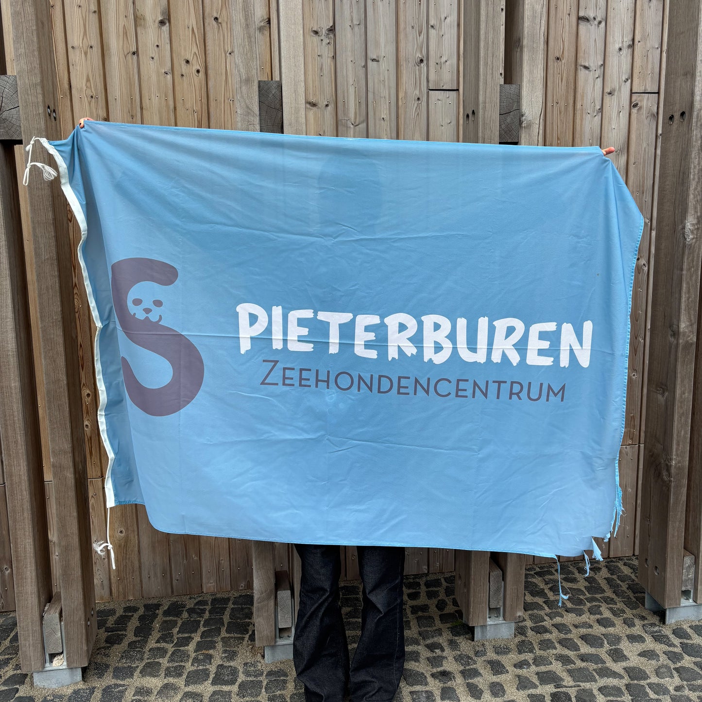 87. Light blue flag featuring the logo of the Seal Centre (used)